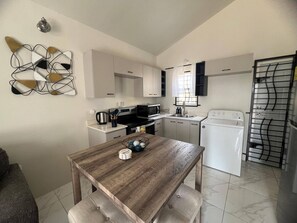Fridge, microwave, stovetop, cookware/dishes/utensils - Charming 2 Bedroom Home in Phoenix Park Village (St. Catherine Parish)