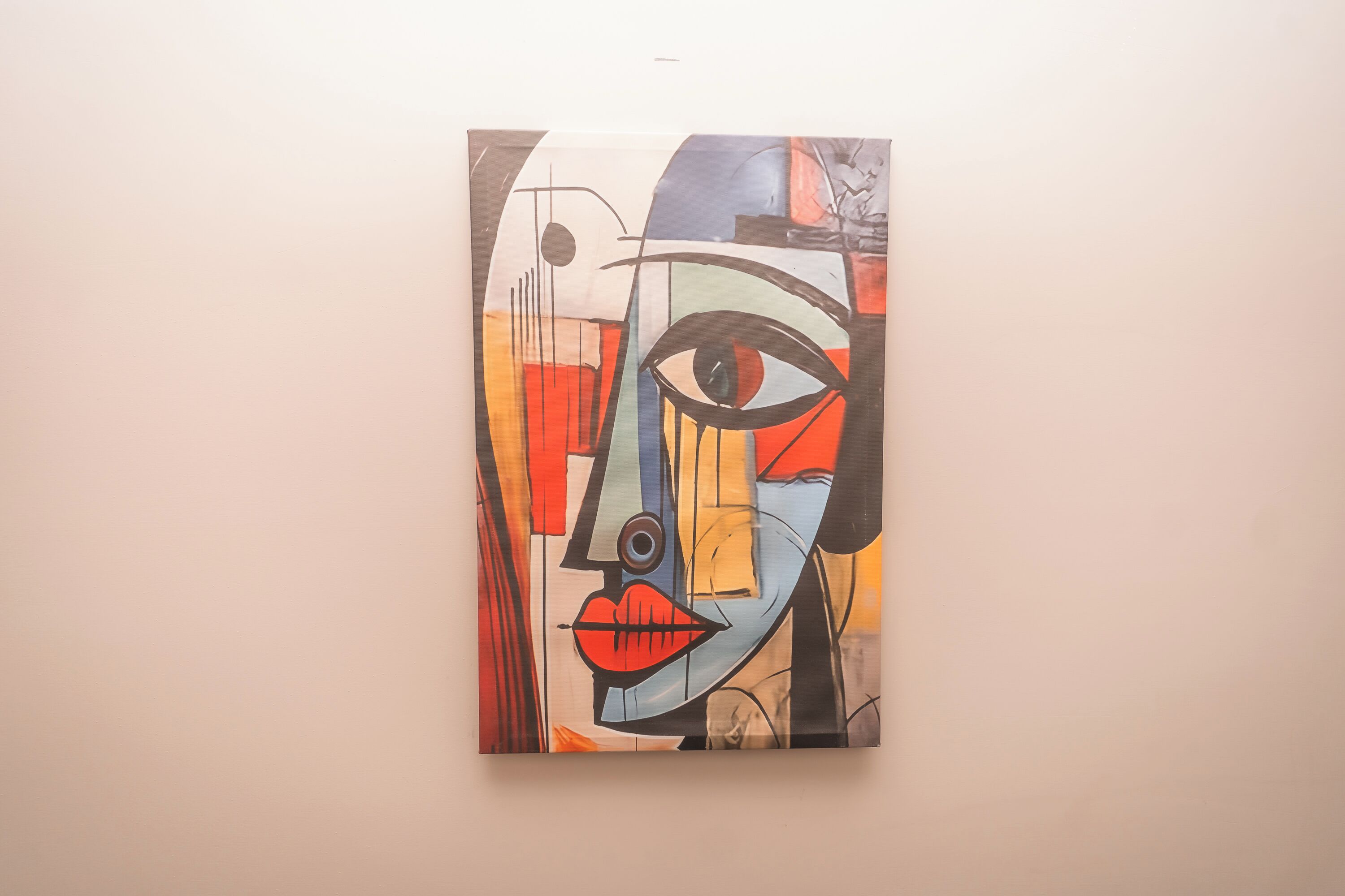 A painting with abstract human features on a wall.