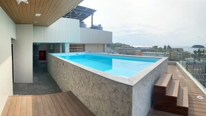 A modern rooftop pool with a clear view of the cityscape. - Asaya Kata (Karon)
