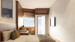 A modern hotel room with a large bed, a seating area with a view, and a large window. - Asaya Kata (Karon)