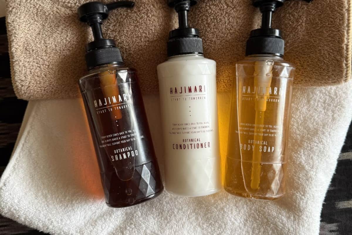 Three bottles of Hajimari products on a towel.