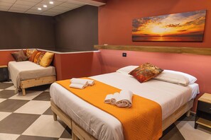 A hotel room with a large bed, two smaller beds, a checkered floor, and a sunset painting on the wall. - Arena Albaro House (Genoa)