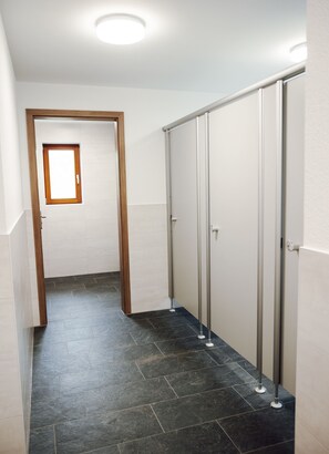 A hallway with a door leading to a room, a window, and a set of metal-framed sliding doors. - Das Fränkische Reichenbach (Reichenbach)