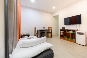 A modern bedroom with a bed, a desk, a chair, and a TV mounted on the wall. - M Pel300i Piso Acogedor de 1 Dormitorio en el Cen (Madrid)