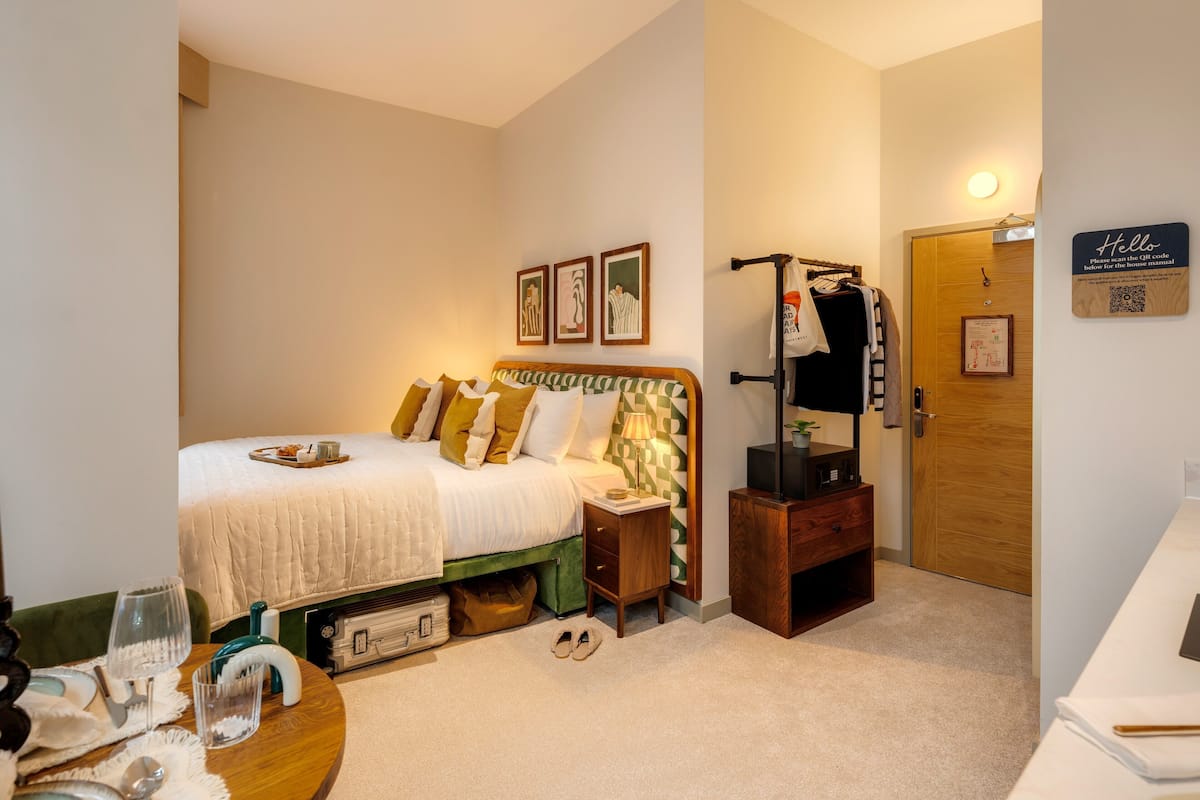 A neatly arranged bedroom with a bed, bedside table, and a wardrobe.