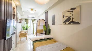 Design Condo, City View | Living area | 43-inch flat-screen TV with digital channels