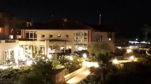 A modern hotel with a spacious outdoor area featuring a pool, sun loungers, and a well-lit patio. - Perfect 2-bedroom apartment with AC in pleasant Fréjus (FRÈJUS)