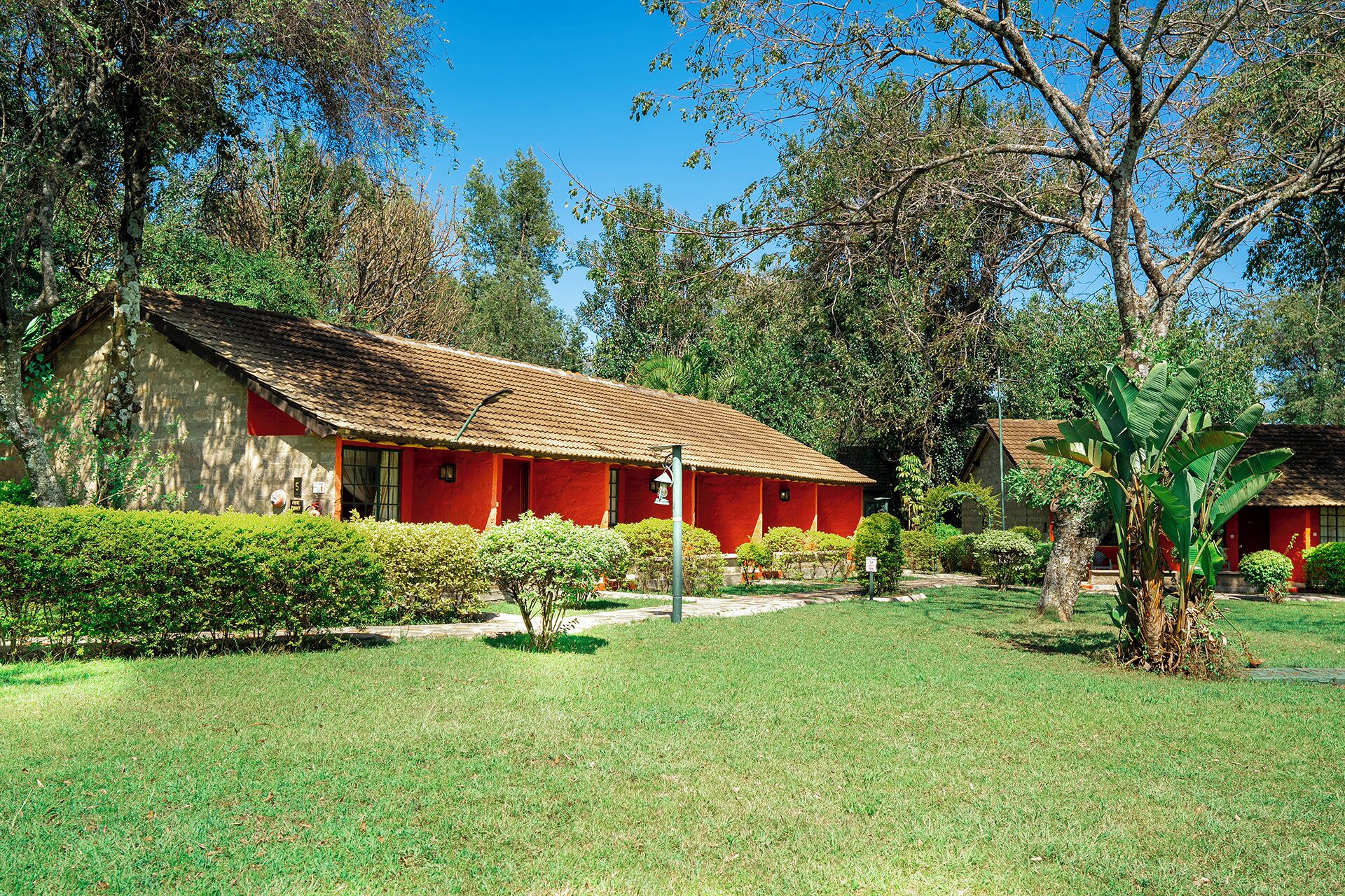 A red-roofed building with a garden in front.
