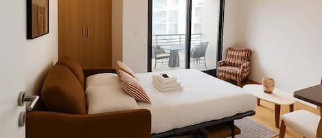 Desk, iron/ironing board, bed sheets