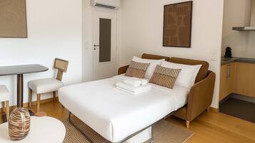 Desk, iron/ironing board, bed sheets