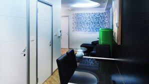 A modern interior with a curved ceiling, a dining area with a glass table, black chairs, and a green refrigerator. - Royal 3-bedroom apartment in Strong Center of Belgrade with Private Garage (Belgrade)