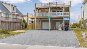 A two-story building with a covered front porch and a garage. - 2nd Wind - 2nd Row 3 BR Home - 2nd Floor Observation Deck (Surf City)