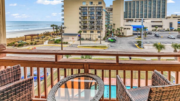 A hotel with a pool, beach view, and multiple floors. - Ocean Dunes Villas (Myrtle Beach)