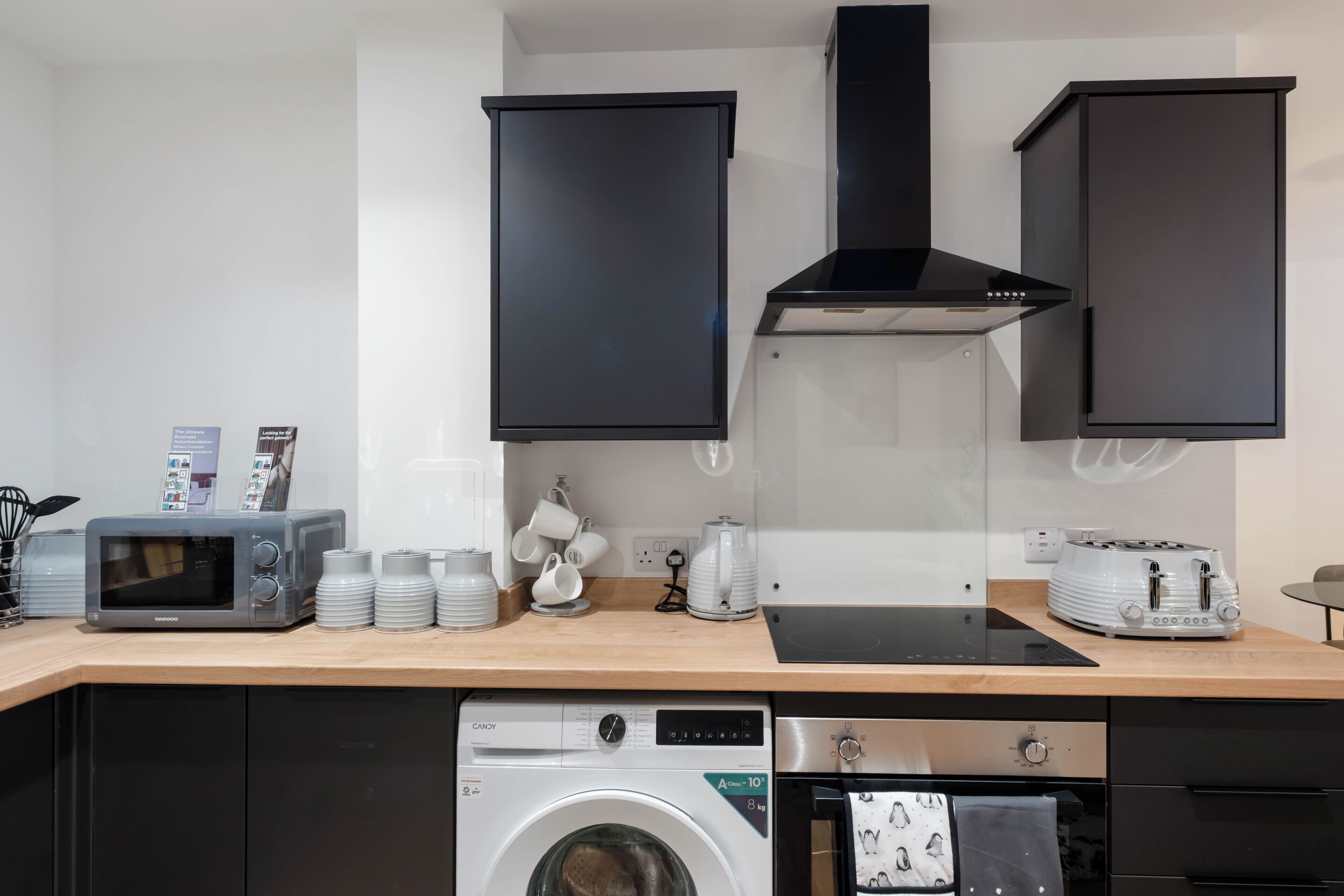 A modern kitchen with a microwave, toaster, and dishwasher.
