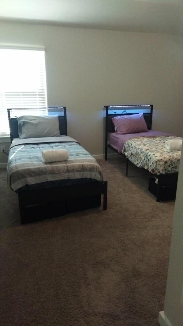 A bedroom with two beds, each with a headboard and a blanket. - Quiet Red Oak Getaway, Pet Friendly and Gameroom (Red Oak)