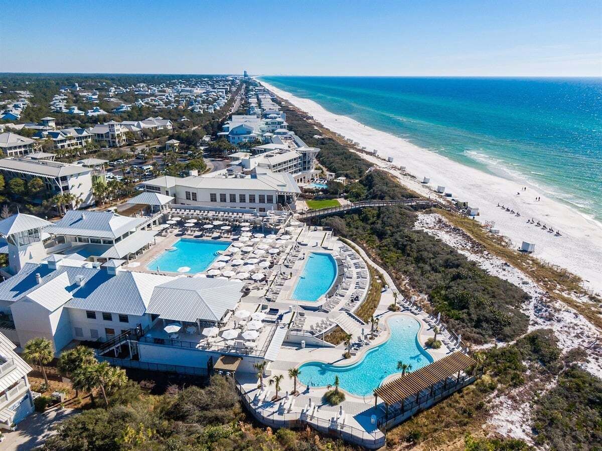 A resort with multiple swimming pools, beachfront access, and a variety of buildings.