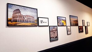 A wall with framed pictures of various landmarks and the word "Roma". - Raffy in Rome (Rome)