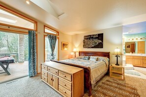 A bedroom with a bed, dresser, and a view of the outdoors. - Steps to Shore: Seaside Olympia Retreat w/ Hot Tub (Olympia)