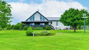A large house with a prominent front porch, a well-maintained lawn, and a clear sky. - Mtn-view Luxe Catskills Retreat for Groups (Hobart)