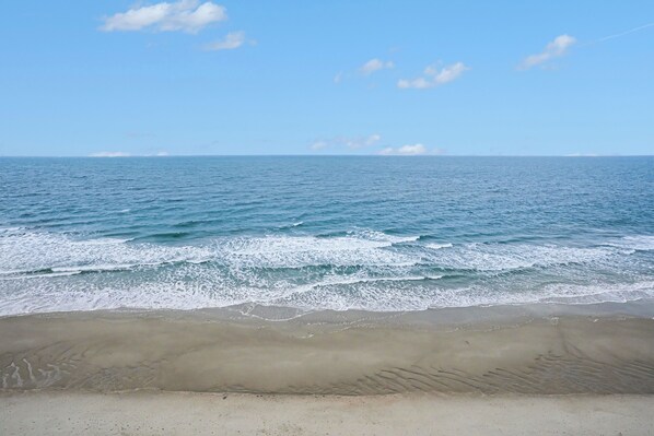 A beach with a clear sky and calm sea. - Oceanfront 1bed/2bath-Water's Edge Resort-1008 Indoor/Outdoor Pool & Hot Tub (Garden City)