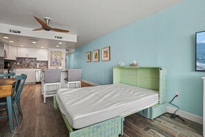 A compact room with a bed, a dining table, and a kitchenette. - Oceanfront 1bed/2bath-Water's Edge Resort-1008 Indoor/Outdoor Pool & Hot Tub (Garden City)