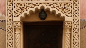 A door with intricate carvings and a small step leading up to it. - Serena's Suite at Gabriel’s Jewel • جوهرة جبرائيل (Rabat)