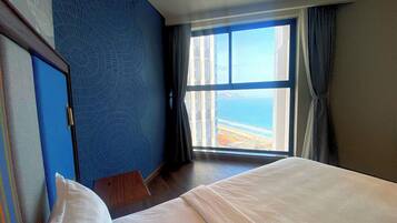 Premium Triple Room, Partial Ocean View | In-room safe, desk, laptop workspace, blackout curtains