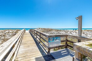 A wooden boardwalk leading to a beach with a sign about sea turtle nesting. - Mainsail 321 2 Bedroom Condo (Miramar Beach)