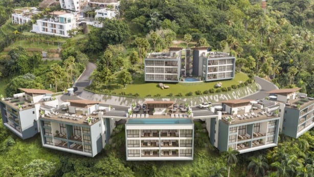 A modern residential complex with multiple buildings, a central courtyard, and lush greenery surrounding the area. - Chic 2BR Apt 1km from Playa Bonita (Las Terrenas)