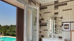 A bathroom with a large window, a white sink, and a mirror. - Villa Sole (Lecce)