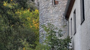 A stone tower with a window, surrounded by trees and a building with a brick roof. - Bed & Breakfast “La Lisière” with Mountain View, Wi-Fi and Air Conditioning (Brantes)