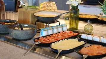A buffet setup with various food items and condiments.