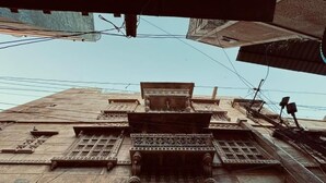 A building with intricate architectural details, including ornate carvings and a central balcony. - HOTEL HIMMAT NIWAS (Jaisalmer)
