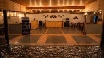 A lobby with a reception desk, seating area, and decorative wall art.