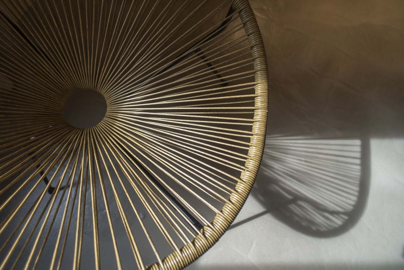 A close-up of a circular, ribbed structure with a central hole, likely part of a ceiling or architectural feature.