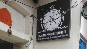 A hostel sign with a logo and address. - NS BACKPACKERS HOSTEL (VARANASI)