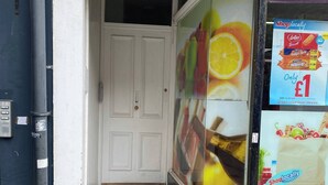 A storefront with a blue sign indicating a money transfer service. - Cozy 1-bedroom Apartment Near Margate Seafront (Margate)