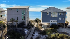 A coastal building with a view of the ocean, a pathway leading to the beach, and a parking area. - ☀️ Pet Friendly - Steps to Beach - Private Pool and Hot Tub - The Lazy Turtle ☀️ (Cape San Blas)