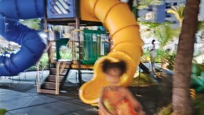 A playground with slides and a climbing structure.