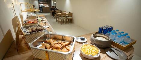 A buffet setup with various food items and beverages.