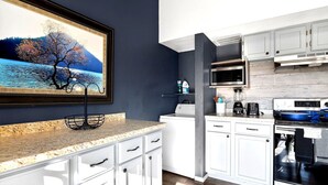 A modern kitchen with white cabinets, a granite countertop, a stainless steel oven, and a microwave. - Lake Views•Near SDC•Game Nights•2 Decks•King Bed•Marina Access•Resort Amenities! (Branson)