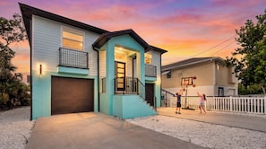 A two-story house with a garage, a balcony, and a basketball hoop. - Beach Getaway - Ask about Special Monthly Rates (Hernando Beach)