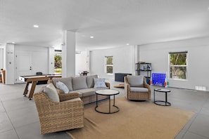 A spacious living area with a pool table, two sofas, and a coffee table. - Beach Getaway - Ask about Special Monthly Rates (Hernando Beach)