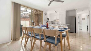 A modern kitchen with white cabinets, a built-in oven, and a refrigerator. - Casa LuCe by Experience Jervis Bay (Old Erowal Bay)