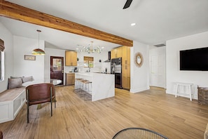 A modern kitchen with wooden cabinets, a central island, and a built-in refrigerator. - Charming 3-bedroom house with AC in sunny Phoenix (Phoenix)
