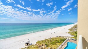 A beach view from a balcony with a pool, clear sky, and ocean. - 🏖️Gulf Front - 2 Beachfront Pools - Great for Families - Seychelles 602🏖️ (Panama City)