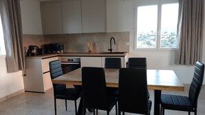 A modern kitchen with a dining area. - Bright and spacious apartment in house located between sea and mountains (Nice)