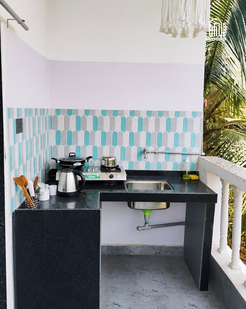 A compact kitchen with a gas stove, sink, and a small countertop.