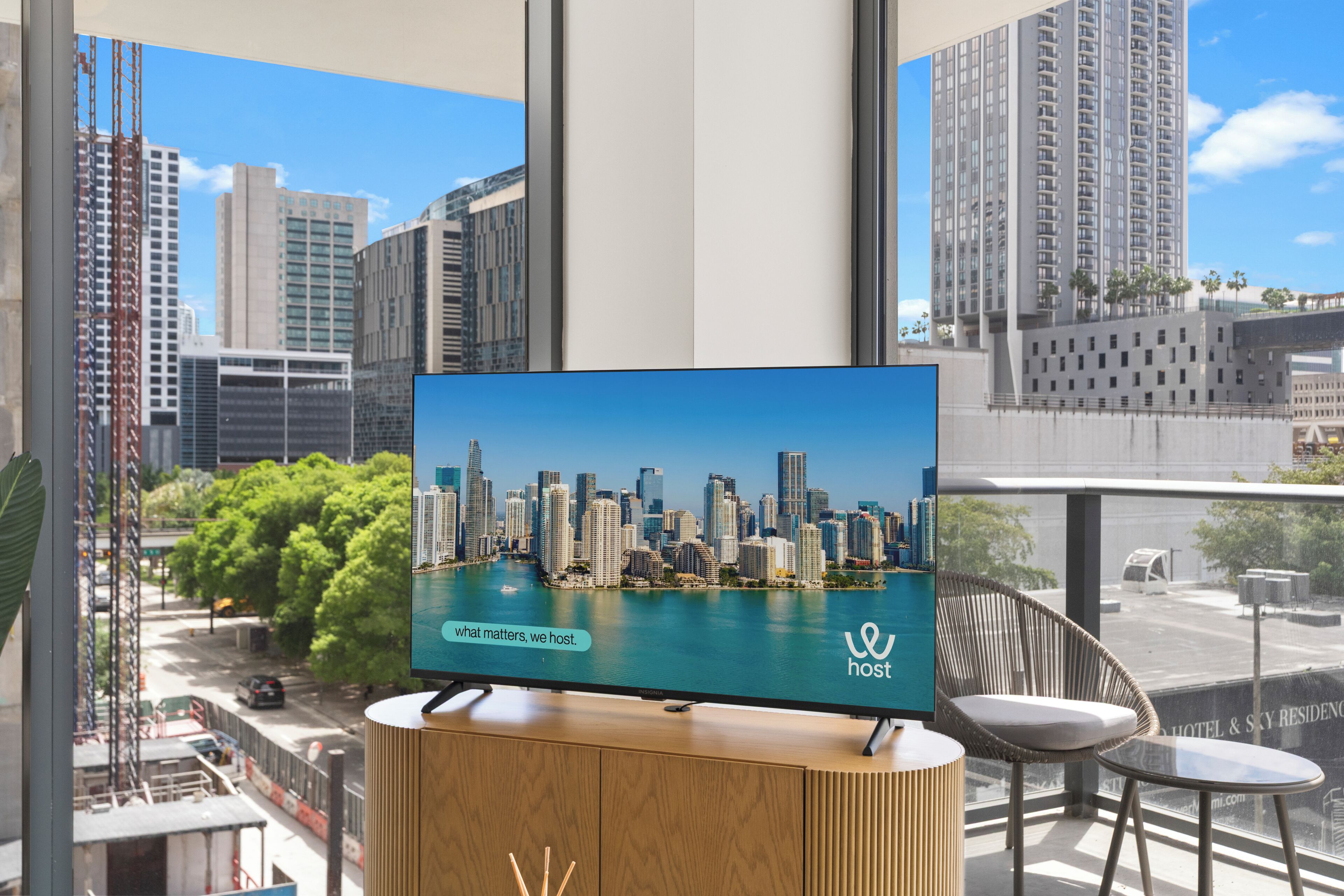 A television displaying a cityscape with a message 'what matters, we host.'