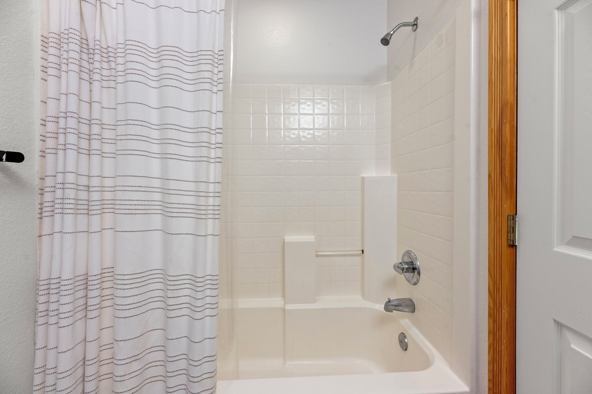 A bathroom with a shower, a bathtub, and a toilet.